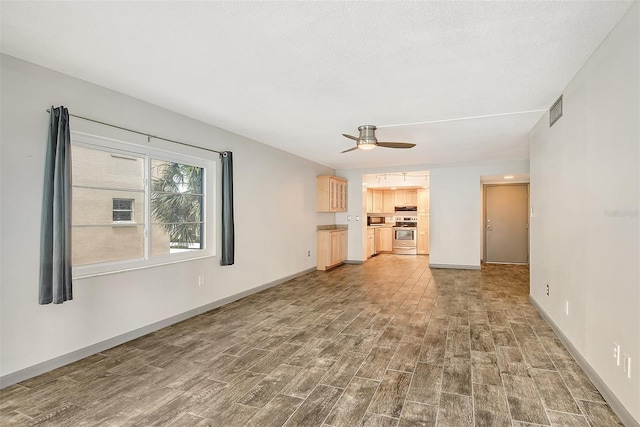 unfurnished living room featuring wood-type flooring and ceiling fan