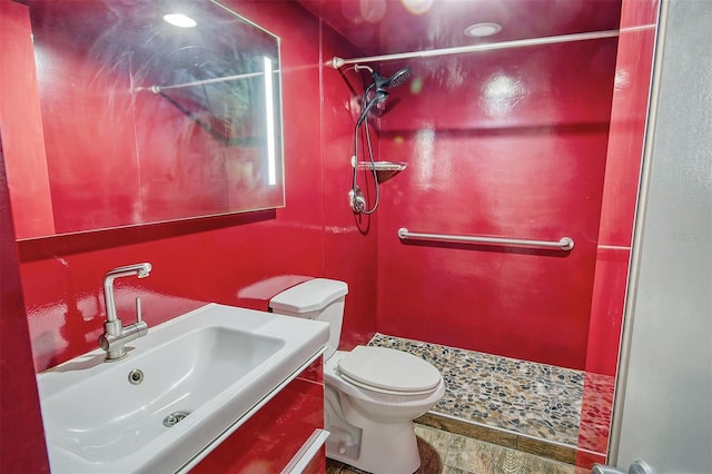 bathroom with vanity, toilet, and a shower