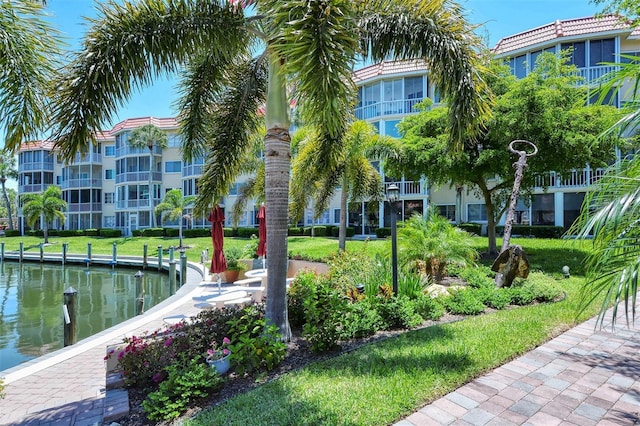 surrounding community featuring a yard and a water view