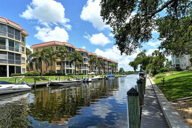 view of dock featuring a water view and a lawn