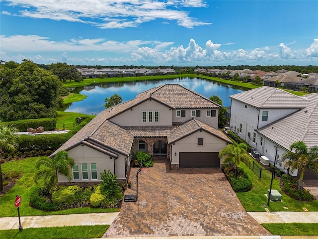 view of front of house featuring a garage and a water view