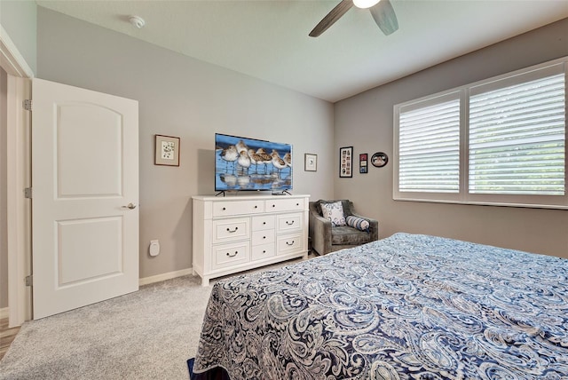 bedroom with ceiling fan and light colored carpet