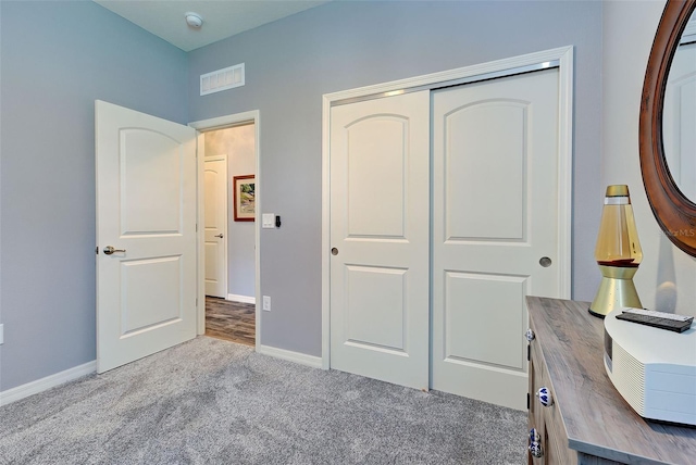 unfurnished bedroom featuring light colored carpet and a closet