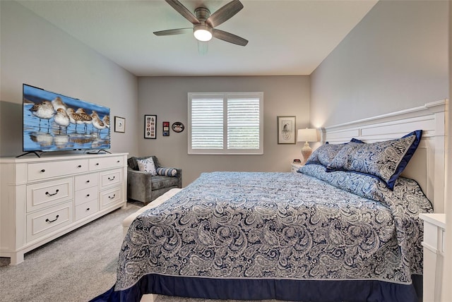 bedroom featuring light carpet and ceiling fan