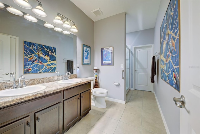 bathroom with vanity, toilet, and tile patterned flooring