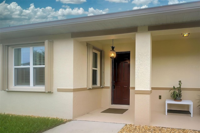 8930 Tuscany Isles Dr, Punta Gorda, FL 33950 - view of exterior entry featuring stucco siding