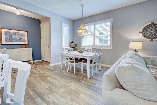 8930 Tuscany Isles Dr, Punta Gorda, FL 33950 - dining area with light wood-style floors and a chandelier