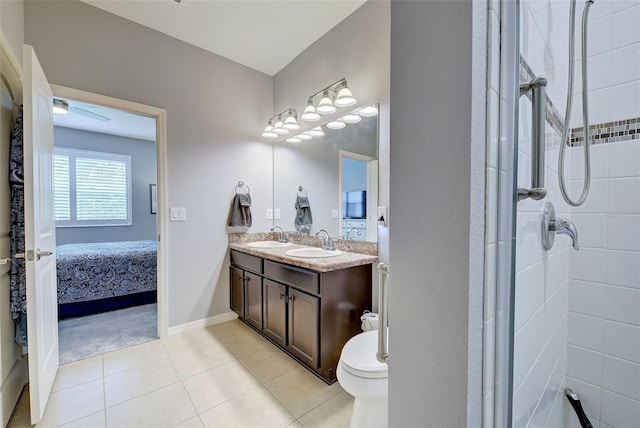 8930 Tuscany Isles Dr, Punta Gorda, FL 33950 - ensuite bathroom featuring double vanity, a tile shower, tile patterned floors, and ceiling fan