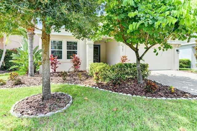 view of front of house with a garage and a front yard