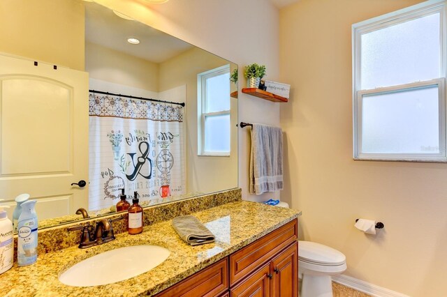 bathroom featuring vanity and toilet