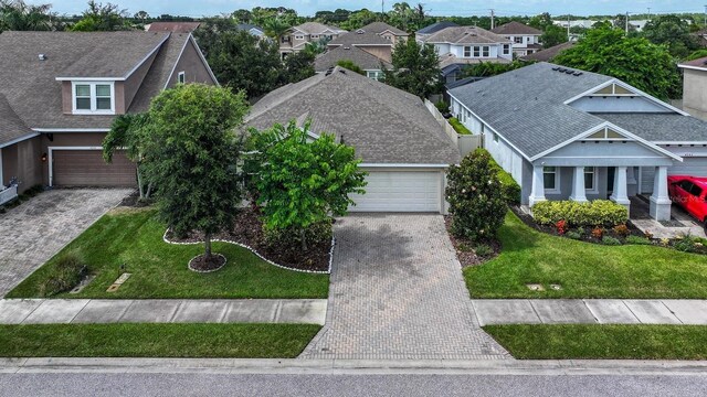 view of front of property featuring a garage and a front lawn