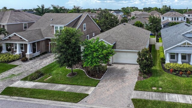 view of front of property with a garage and a front lawn