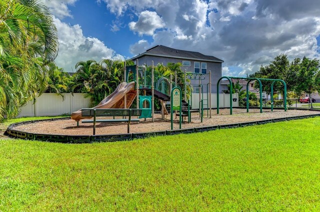 view of playground with a lawn