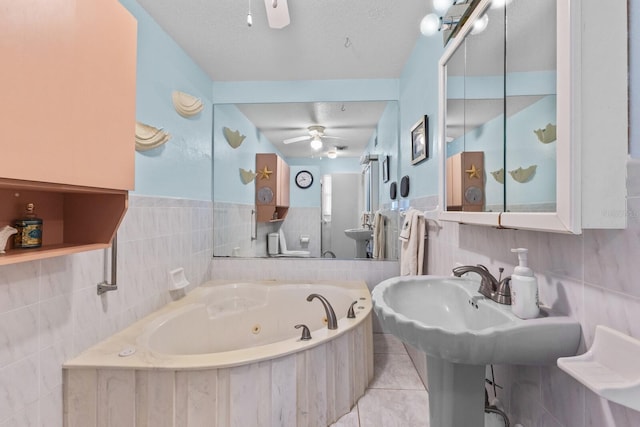 bathroom featuring tile patterned flooring, a washtub, a textured ceiling, and ceiling fan