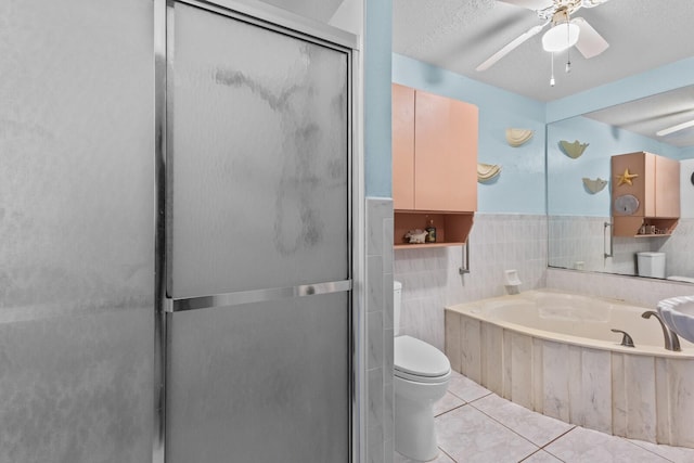 bathroom with plus walk in shower, tile walls, toilet, tile patterned floors, and a textured ceiling