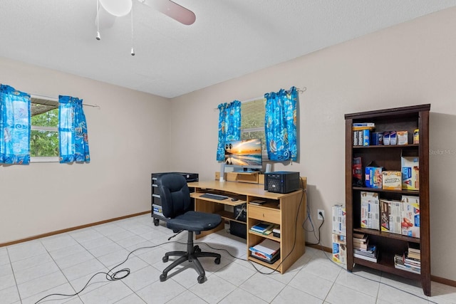 tiled office space featuring ceiling fan and a textured ceiling