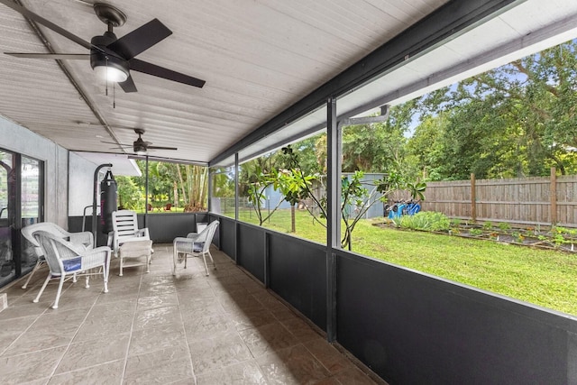 sunroom with ceiling fan and plenty of natural light