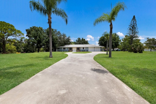 ranch-style home with a garage and a front yard