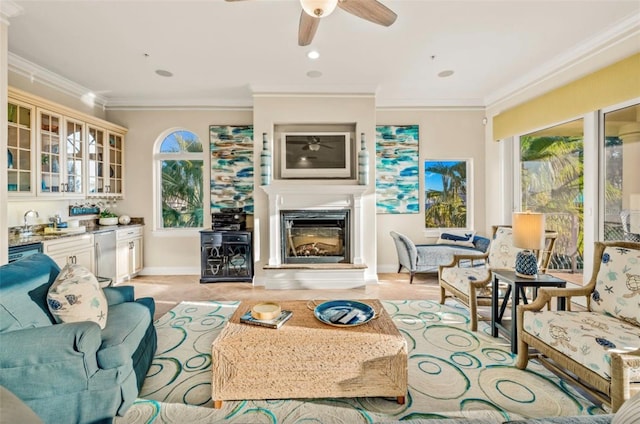 tiled living room with ceiling fan, a wealth of natural light, and crown molding