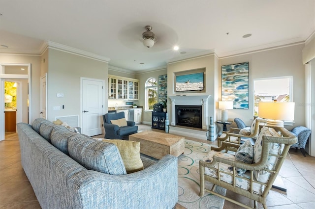 living room featuring ceiling fan, light tile patterned floors, and ornamental molding