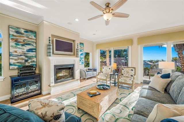 living room featuring ceiling fan and ornamental molding