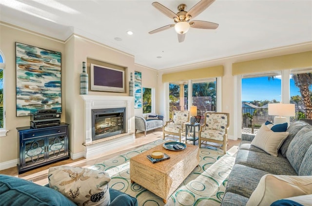 living room with ceiling fan and crown molding