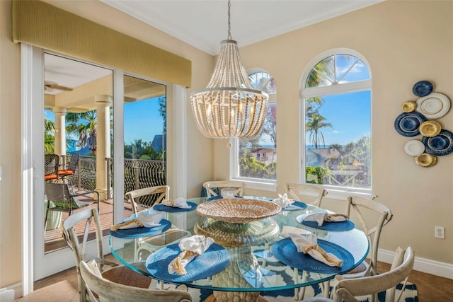 tiled dining space with an inviting chandelier and a wealth of natural light