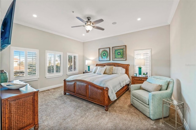 carpeted bedroom featuring ceiling fan and crown molding