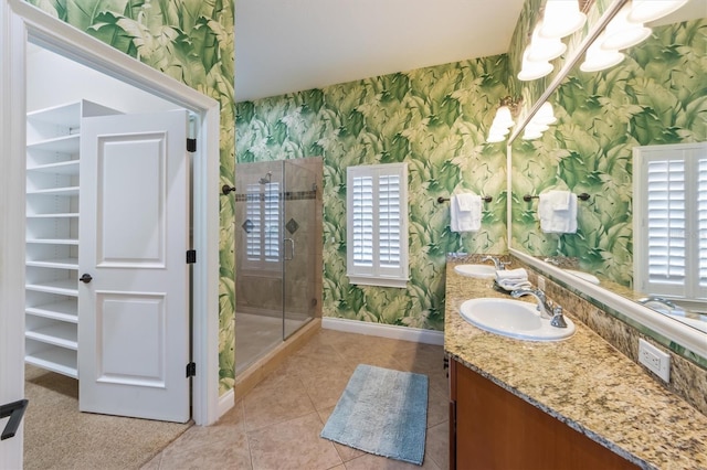 bathroom with a notable chandelier, a shower with door, vanity, and tile patterned flooring