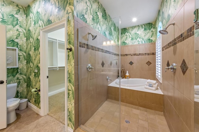 bathroom with tile patterned floors, toilet, and shower with separate bathtub