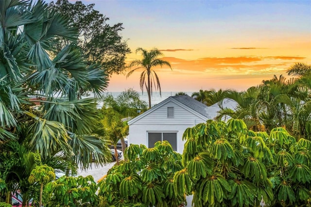 property exterior at dusk with a water view