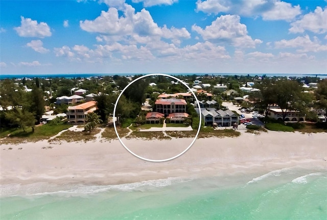 drone / aerial view featuring a beach view and a water view