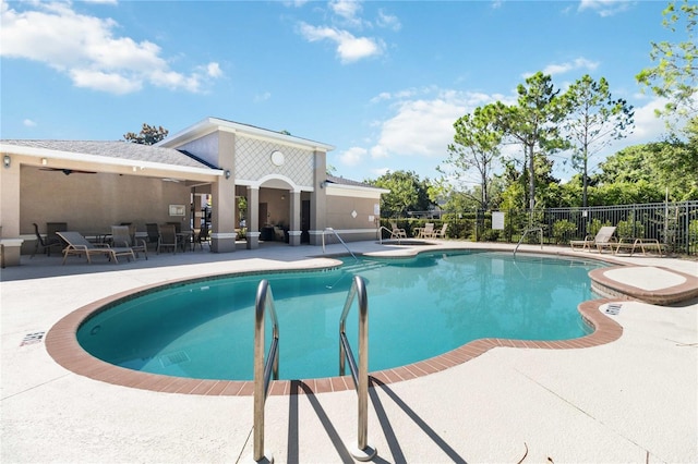 community pool featuring a patio area and fence