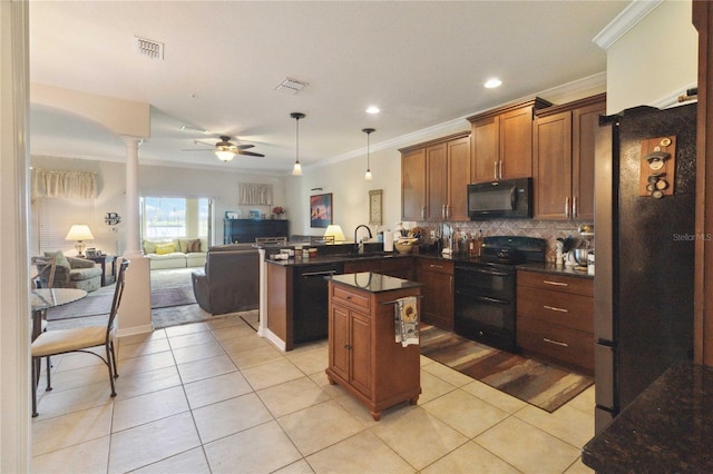 kitchen featuring a peninsula, a sink, black appliances, dark countertops, and a center island