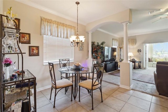 dining room with visible vents, crown molding, decorative columns, light tile patterned floors, and arched walkways