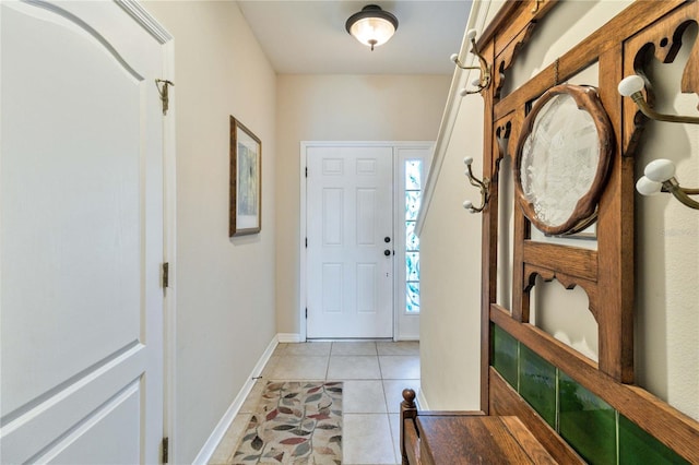 foyer with light tile patterned flooring and baseboards