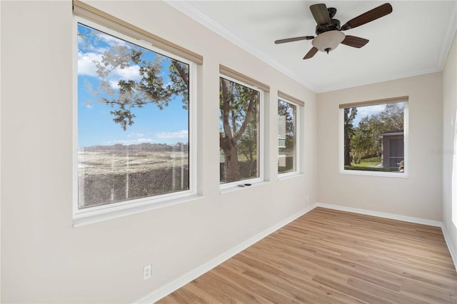 unfurnished sunroom featuring ceiling fan