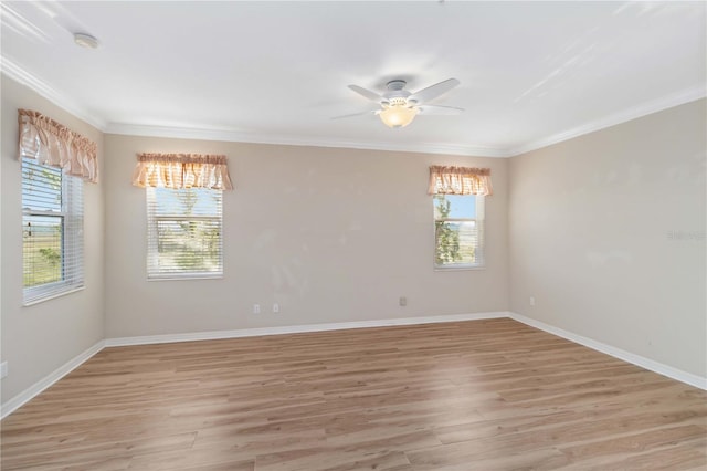 empty room with light wood finished floors, a ceiling fan, baseboards, and ornamental molding