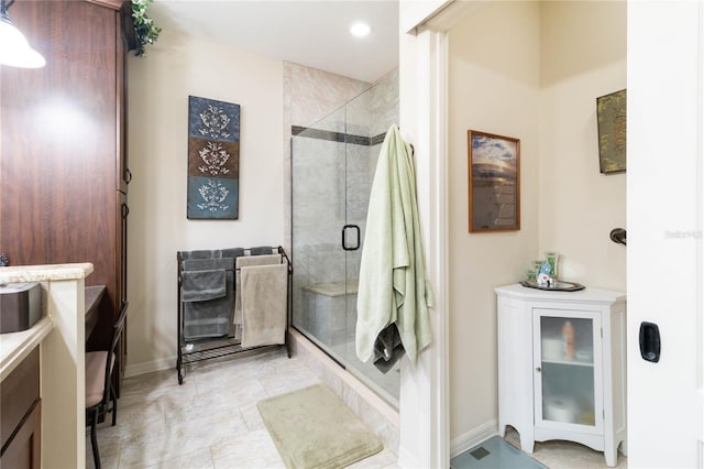 bathroom featuring recessed lighting, baseboards, and a shower stall