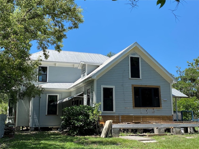 rear view of house with a lawn