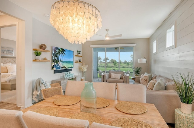 dining area with wood-type flooring and ceiling fan