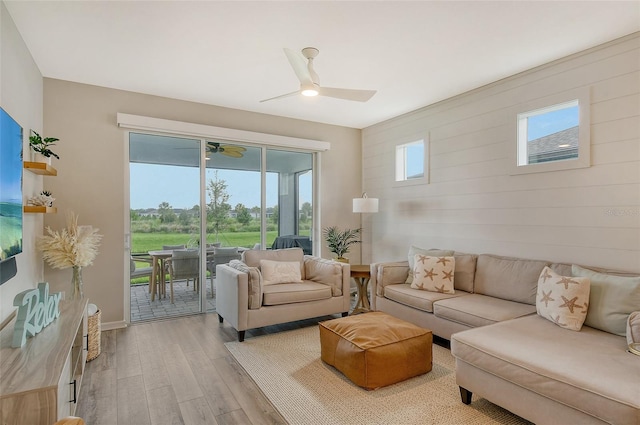 living room featuring light hardwood / wood-style floors and ceiling fan