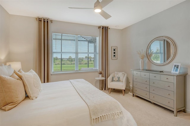 bedroom featuring light colored carpet and ceiling fan