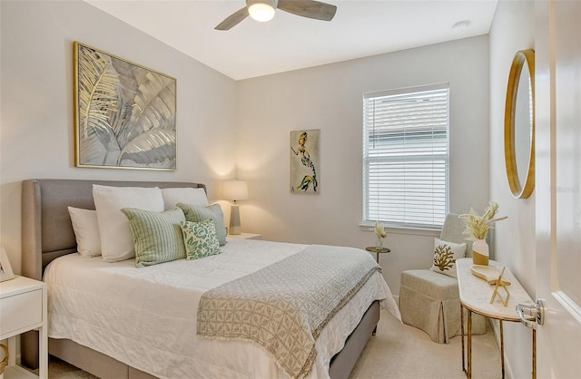 bedroom featuring light colored carpet and ceiling fan