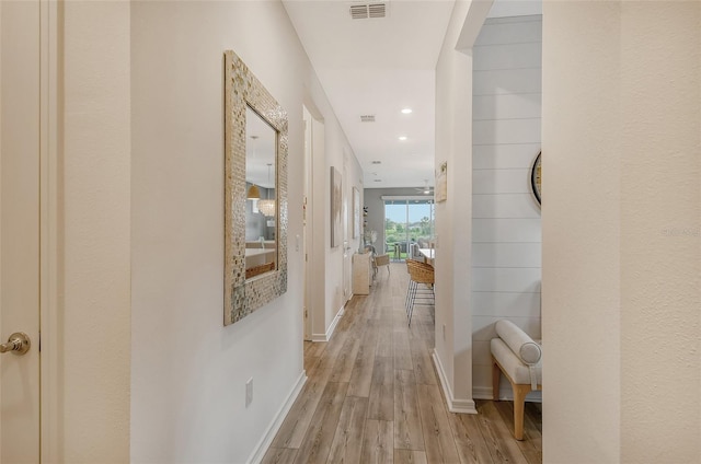 hallway with light hardwood / wood-style floors