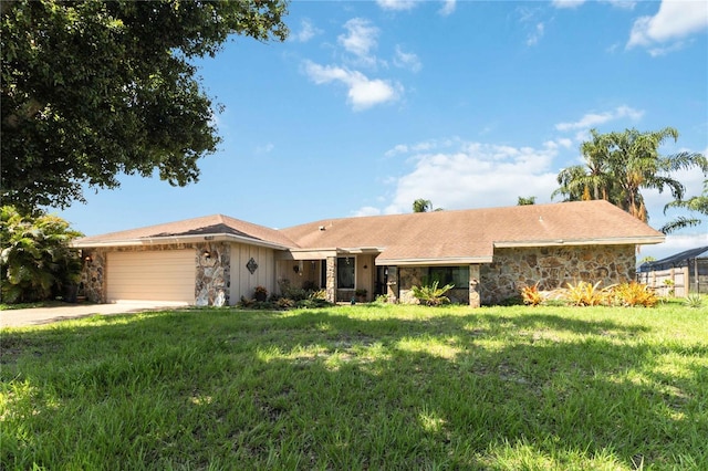 single story home featuring a garage and a front lawn