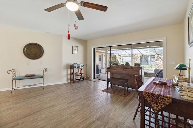 dining area featuring ceiling fan and wood-type flooring