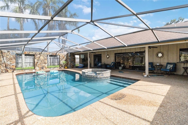 view of swimming pool featuring an in ground hot tub, a patio, glass enclosure, and ceiling fan