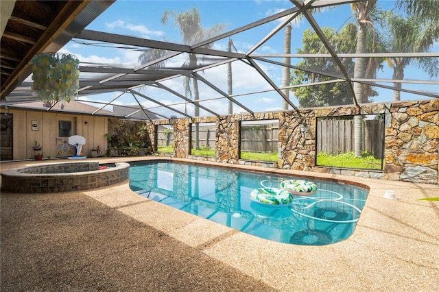 view of swimming pool featuring an in ground hot tub and a lanai