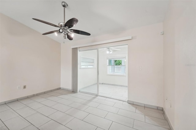 tiled spare room with ceiling fan